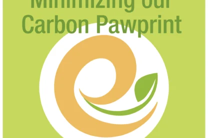 A green and orange logo with a leaf and the text "Minimizing our Carbon Pawprint" on a light green background.