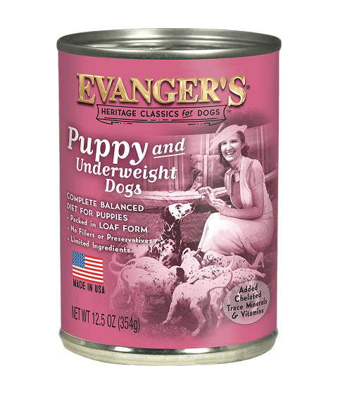 A case of 12 cans of Heritage Classic Puppy Food, 12.5 oz each, with a pink label featuring a woman and puppies plus nutrition details.