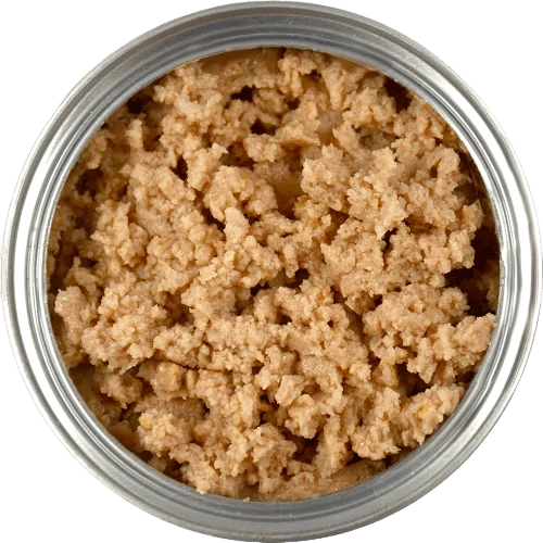 A close-up top view of an open can containing moist, light brown, crumbly pet food.