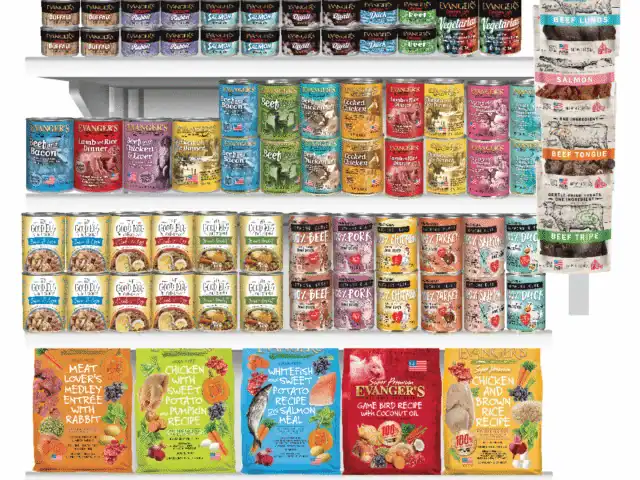 Retail display of Evanger’s pet food products, including canned food, dry food bags, and treats, arranged on shelves with a 90-year anniversary sign at the top.